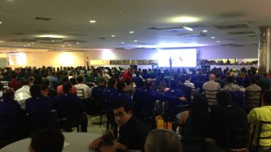 Palestrante de vendas Alexandre Bernardo falando em evento corporativo para equipe comercial.